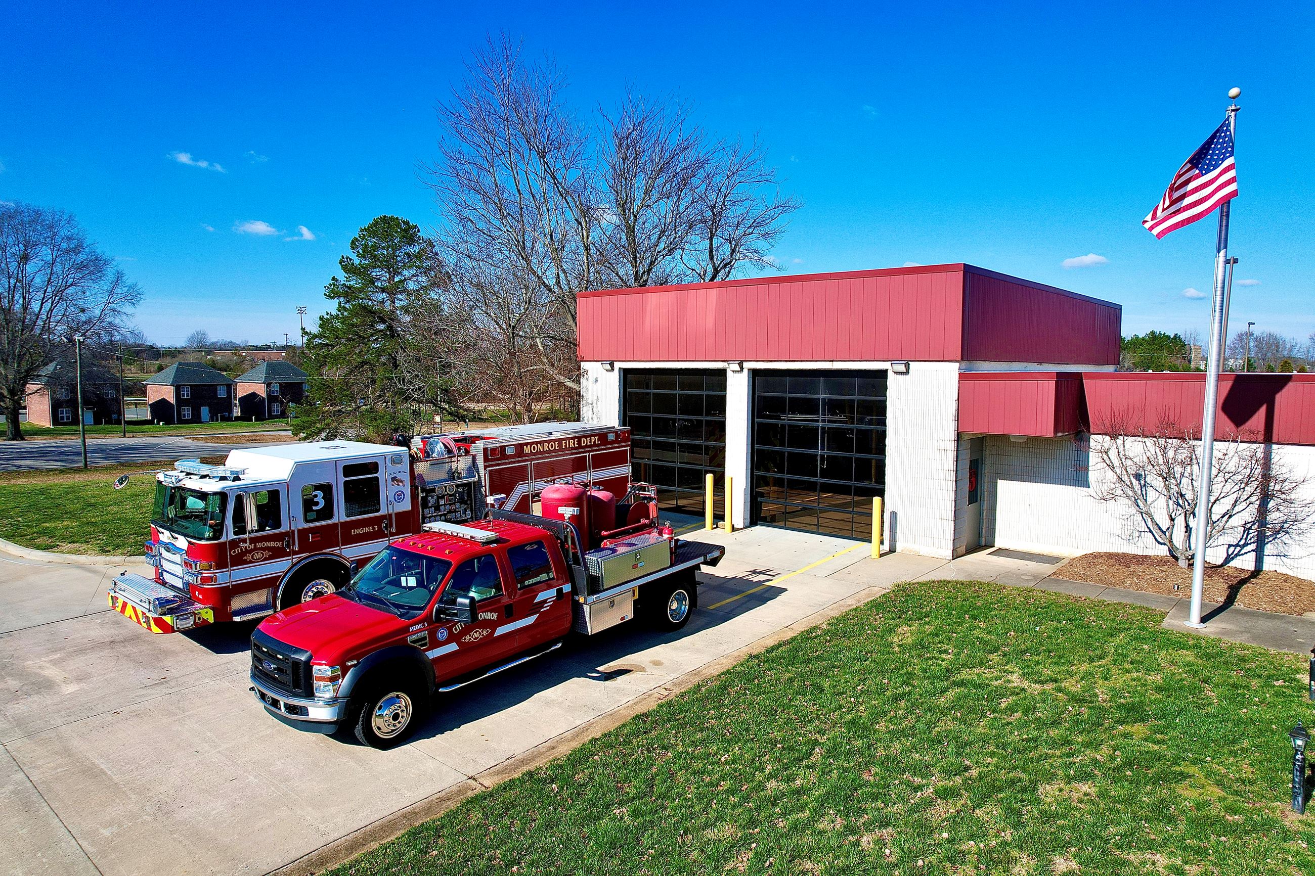 City of Monroe Station 3 with Fire Trucks pulled out and American Flag flying on post