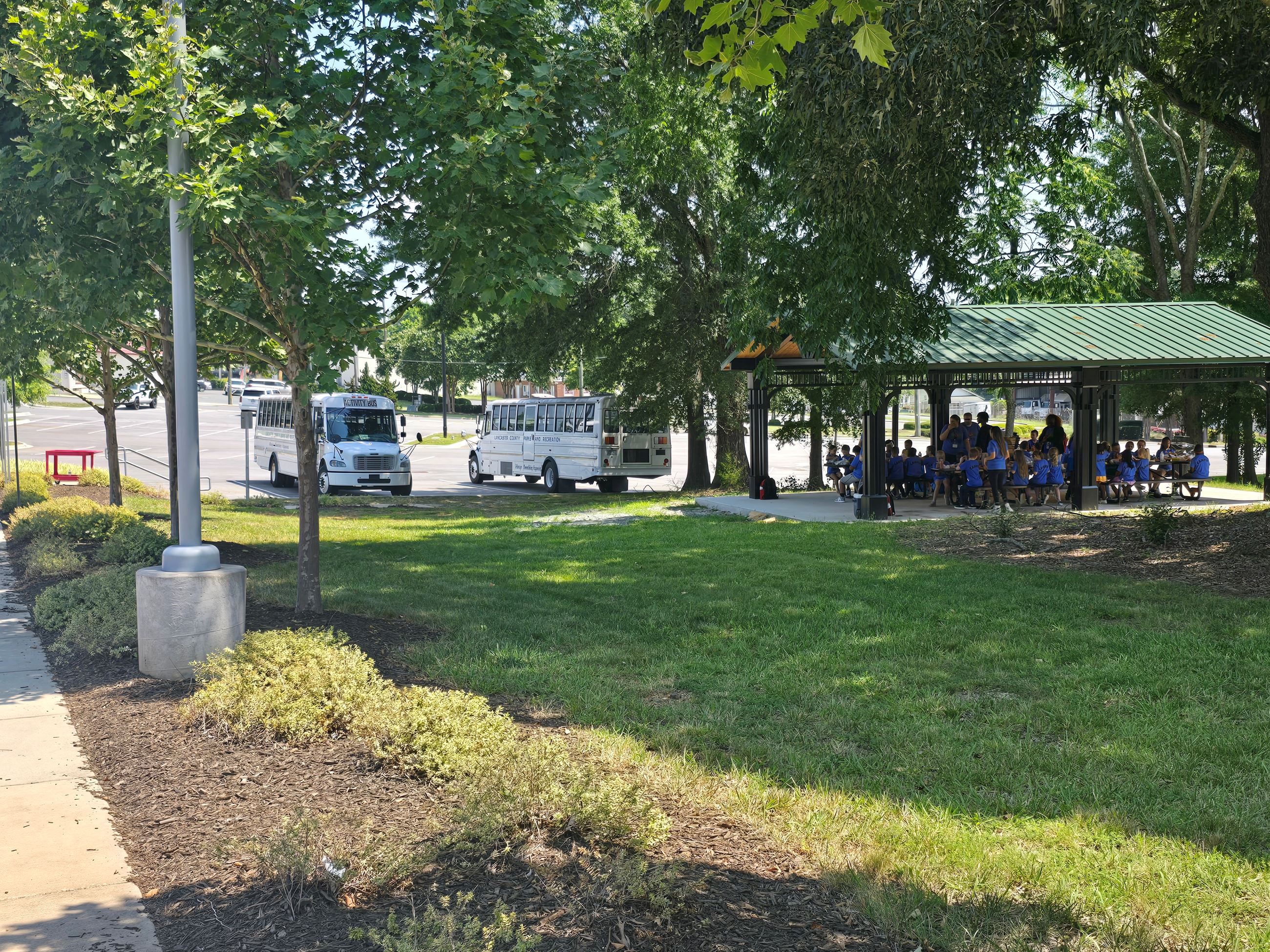 A group of school children eat lunch outside of the Monroe Science Center.
