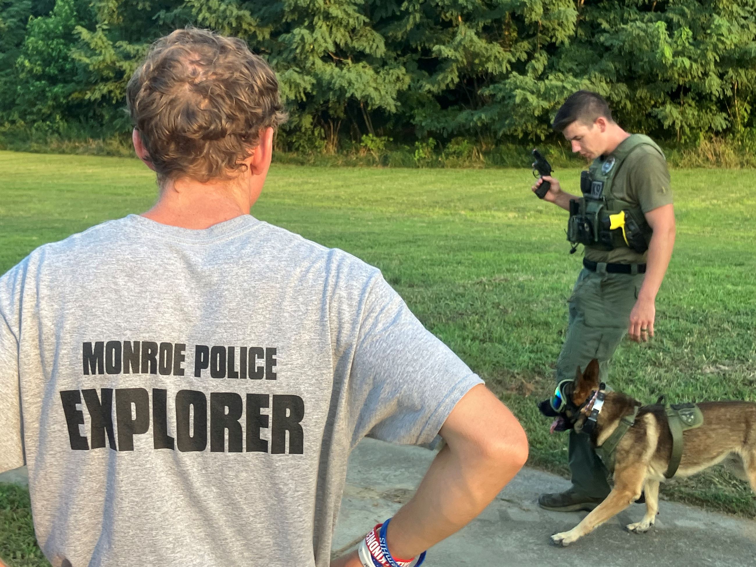 A Police Explorer watches a K-9 demonstration outside.